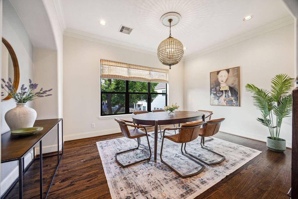 Dining room with hardwood floor and designer light fixture