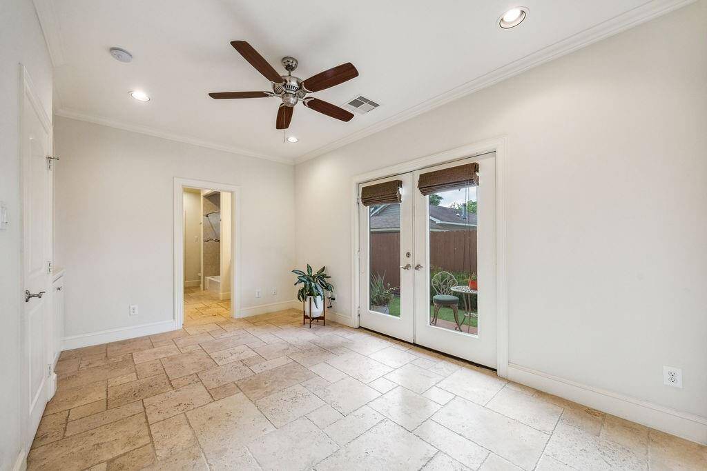 First floor bedroom w/ ensuite bath and access to the private yard.