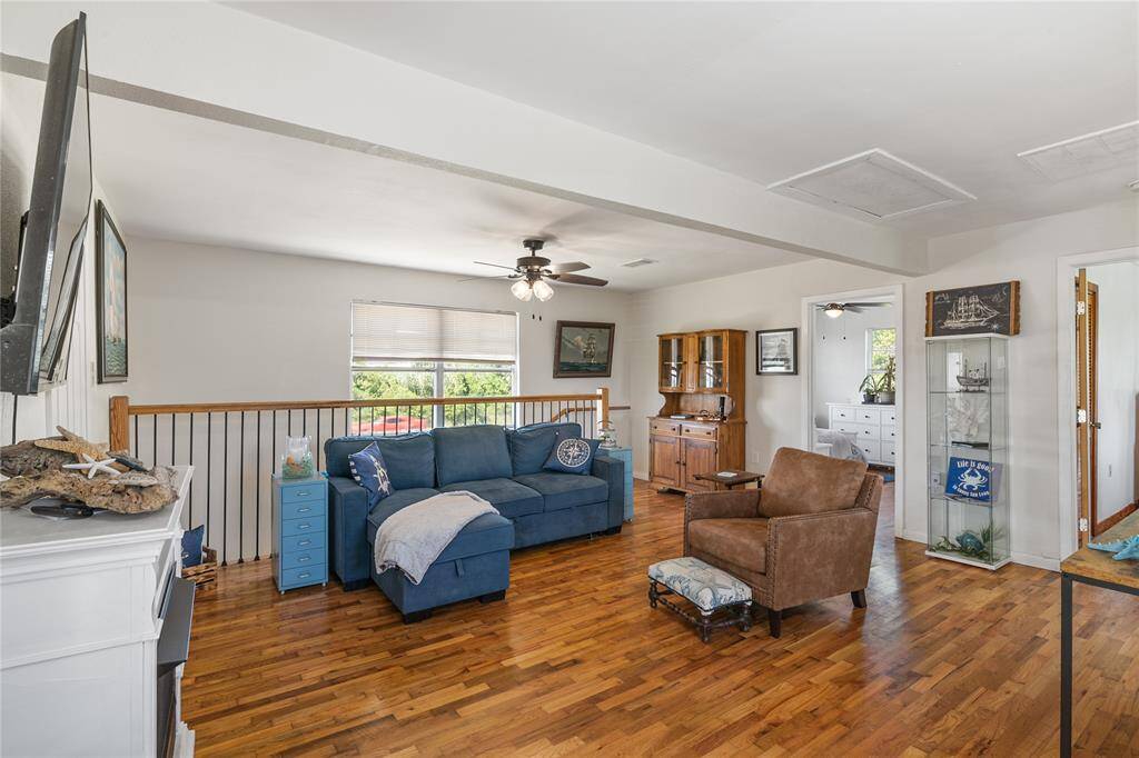 Welcoming second-floor family room with abundant natural light, hardwood floors, and space for relaxation and entertainment.
