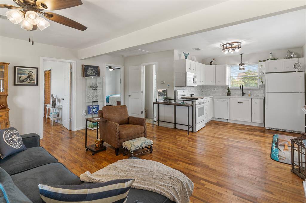 Spacious and inviting family room seamlessly connected to a modern kitchen on the second floor, perfect for entertaining.
