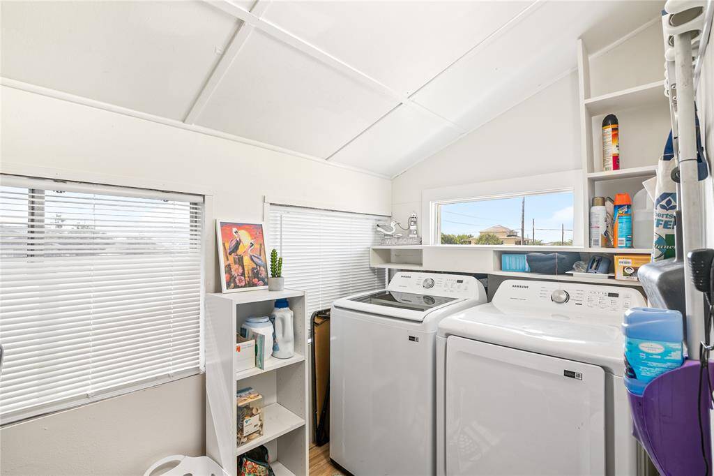 Convenient second-floor utility room with ample storage and natural light.