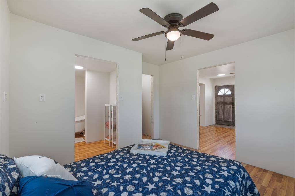 Cozy first-floor bedroom with natural light, hardwood floors, and an en-suite bathroom for added convenience.