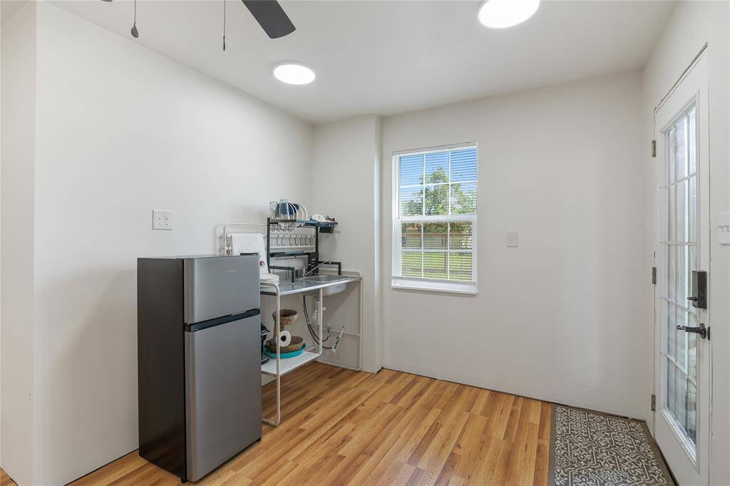 Experience comfort and functionality in this first-floor family room, seamlessly connected to a kitchenette. Features include a convenient under-stair storage closet and a secure safe room closet.