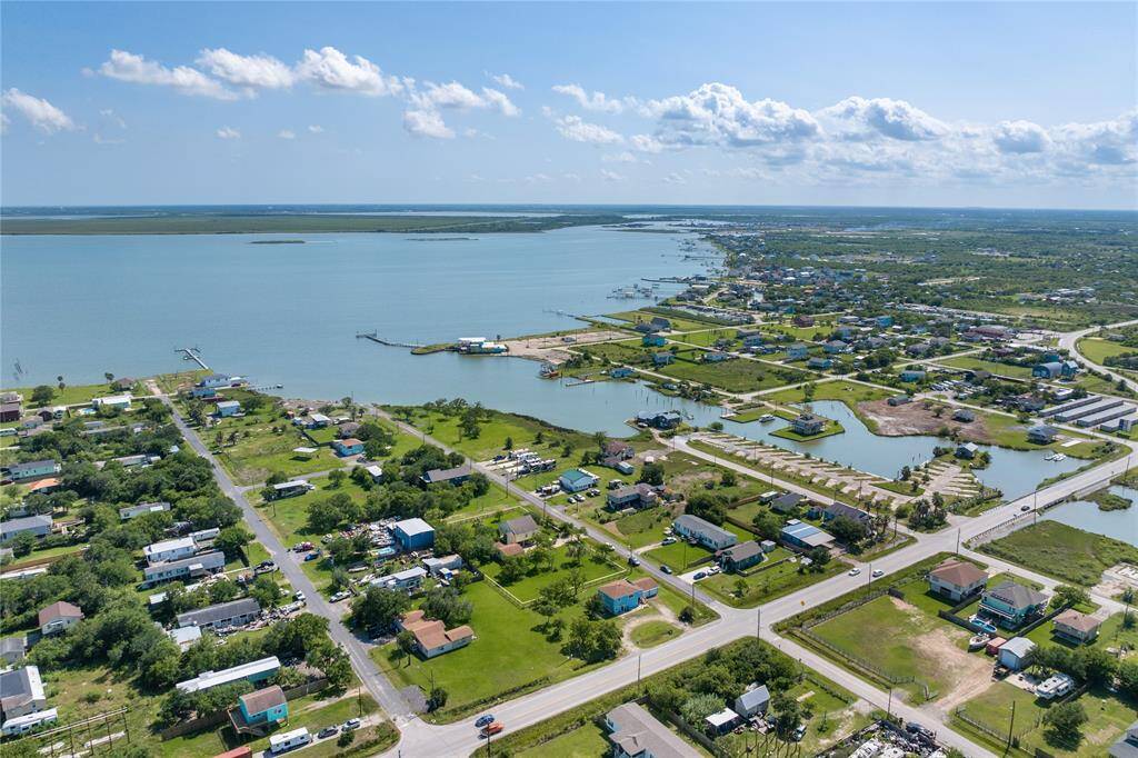 Experience the perfect location with this aerial view showcasing your future property, conveniently situated near FM 517 and the scenic Factory Bayou.