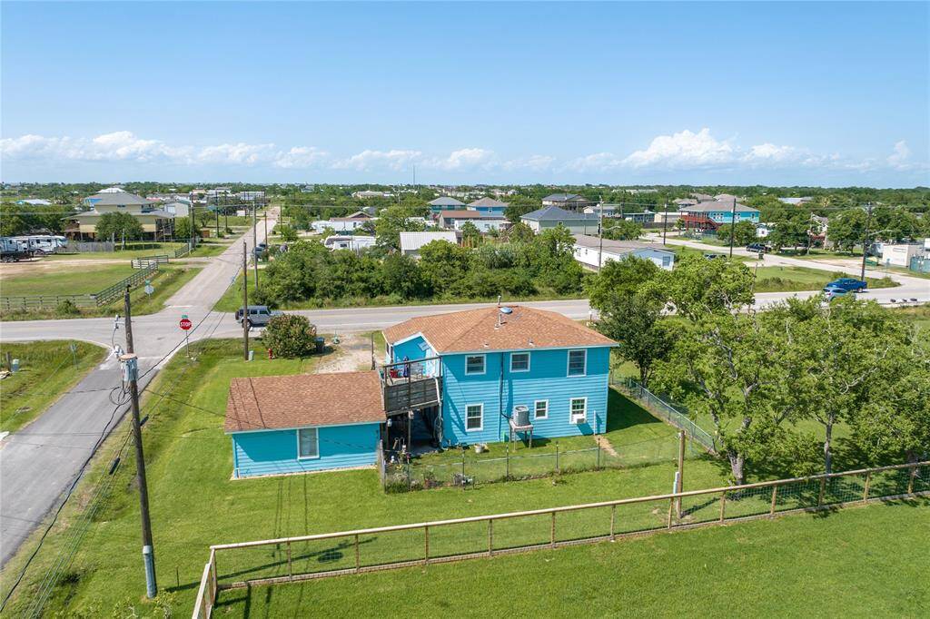 Expansive backyard view showcasing a vibrant, charming two-story home, perfect for relaxation and outdoor activities.