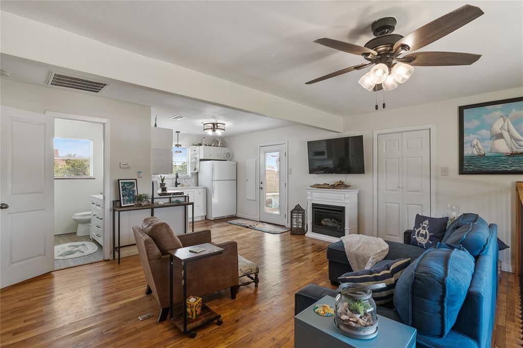 Inviting second-floor family room with cozy seating, a gas fireplace, and easy access to the kitchen and outdoor space. Perfect for relaxation and entertaining.