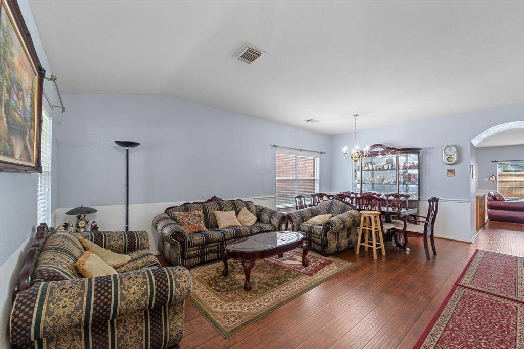 Dining area features elegant wood flooring.  Large windows allow natural light.