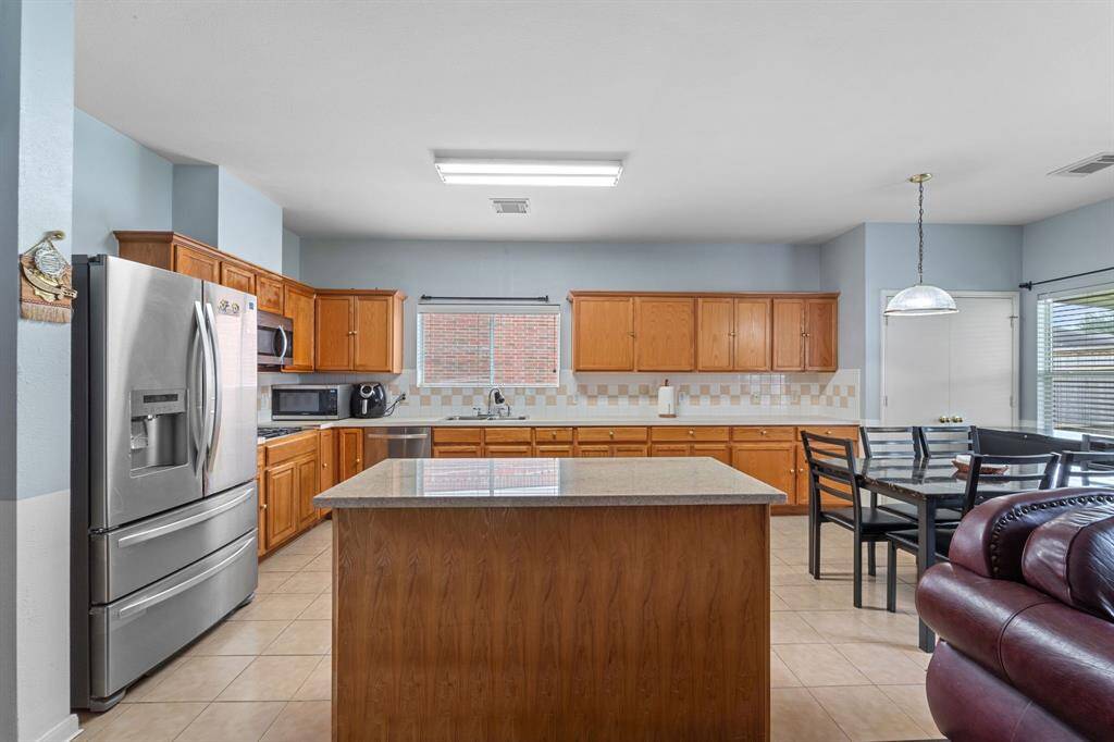 Spacious kitchen with island and breakfast area.
