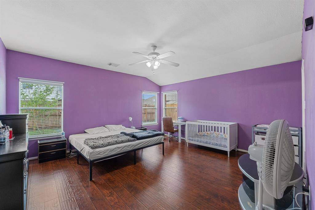 Spacious primary bedroom includes a ceiling fan.