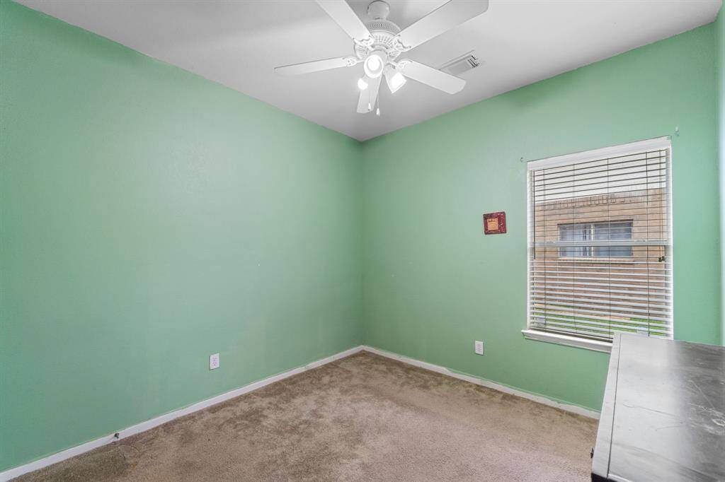 Cozy bedroom with hardwood flooring and ceiling fan.