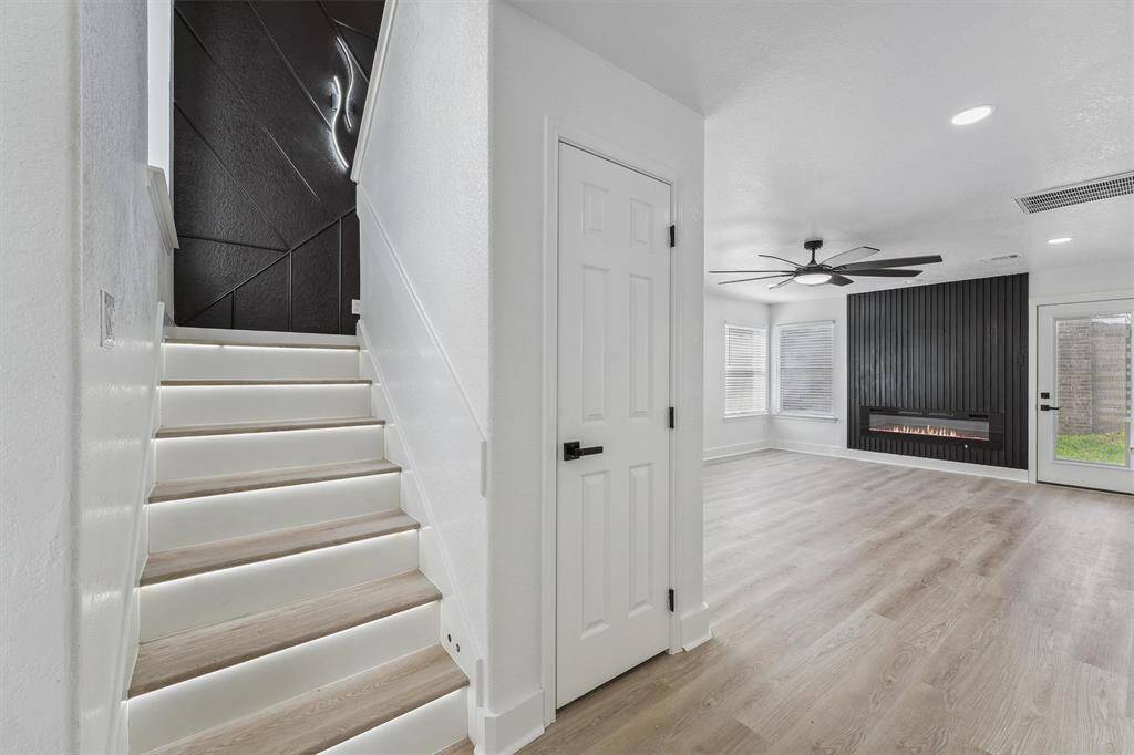As you ascend to the second floor, sensor-activated lighting under the stairs adds a touch of sophistication and modern elegance—both sleek and functional, enhancing the home’s upscale ambiance.