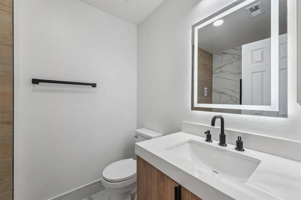 The second full bathroom features a modern LED mirror with built-in defogger and a convenient bathtub/shower combo—perfect for kids to enjoy a relaxing soak or a quick rinse. Stylish and functional for everyday living.