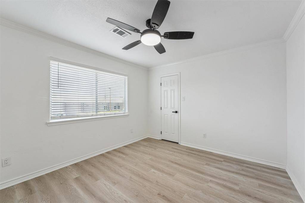 The second bedroom is spacious and comfortable, featuring a ceiling fan to keep cool during warm summer days—ideal for family, guests, or a cozy home office.