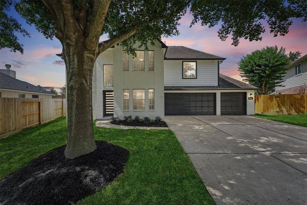 A stunning twilight view showcases the beautiful two-story exterior, with warm lighting highlighting the home’s architectural charm.
