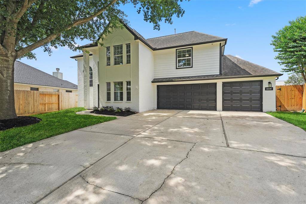 This alternate front view highlights the home's expansive driveway, offering plenty of parking space for guests and family.
