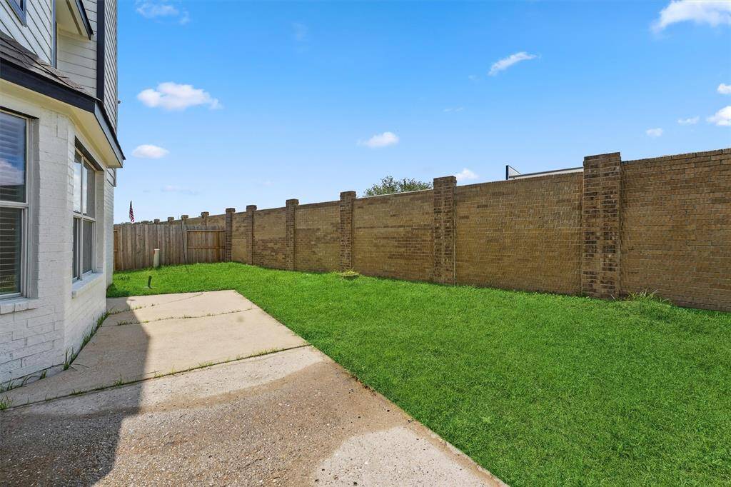 The expansive backyard offers plenty of space for outdoor living, with no back neighbors for added privacy.
