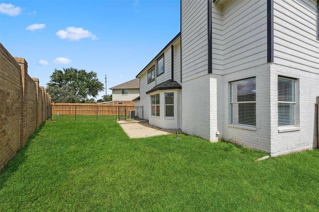 This backyard is perfect for entertaining, relaxing, or letting the kids and pets run freely in a secure and open space.