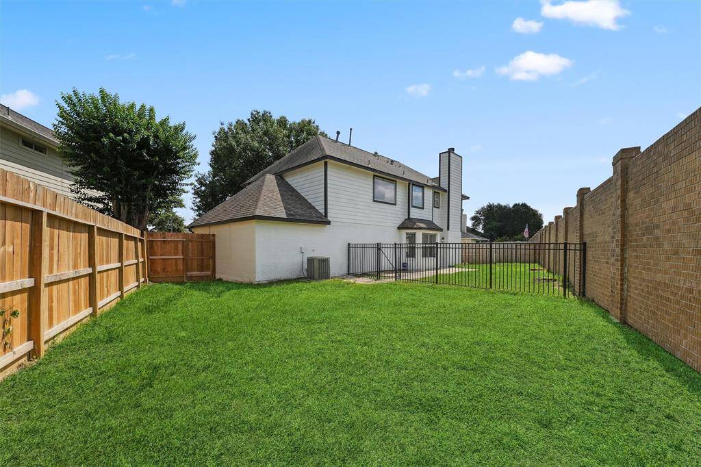A fenced section is ideal for a garden, pet area, or play space—making this yard as functional as it is peaceful.