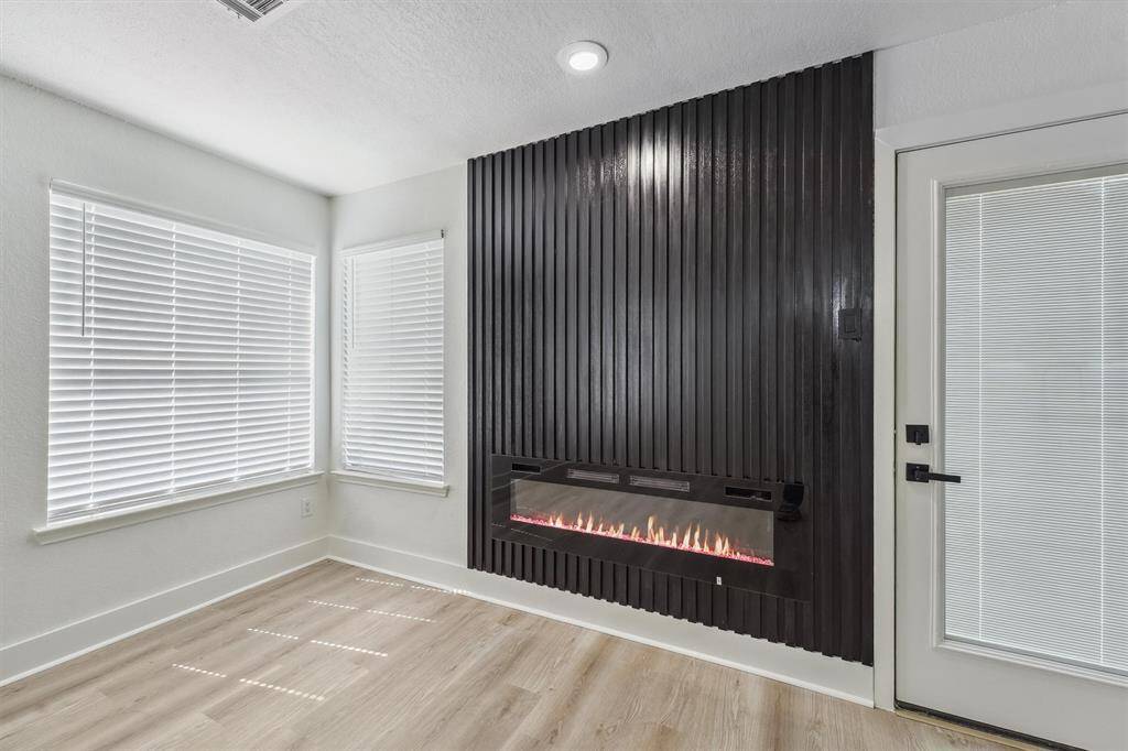 An electric fireplace with customizable LED lighting adds a modern touch and cozy ambiance, perfect for relaxing or entertaining.