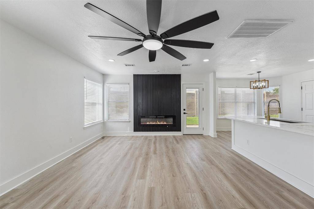 The open-concept layout seamlessly connects the living room and kitchen, creating the perfect setting for entertaining guests.