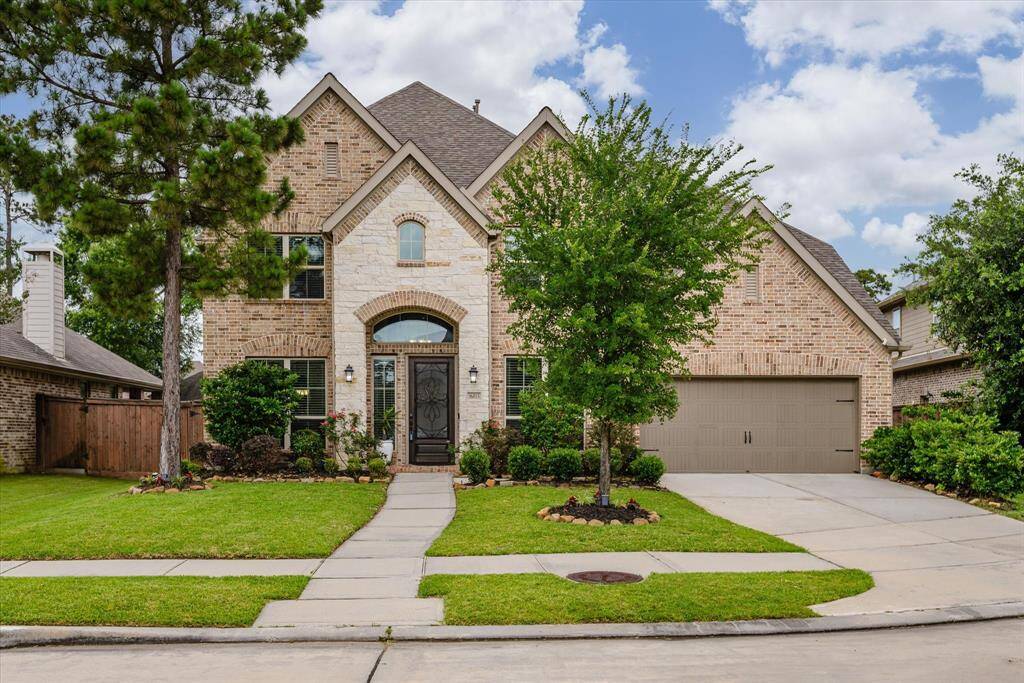 Charming curb appeal welcomes you home with a manicured lawn, inviting entry, and beautifully maintained exterior.