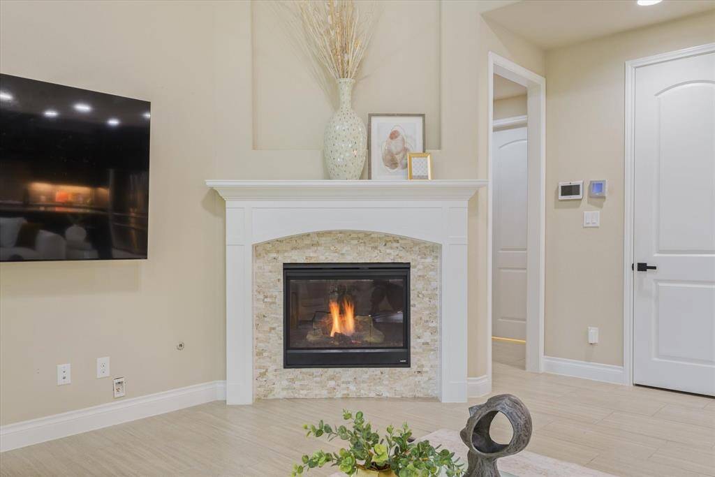 Cozy up by the fireplace with plenty of space for your TV—an ideal spot for relaxing evenings and entertainment.