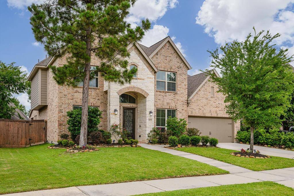 Another angle showcases the home's stunning architecture, lush landscaping, and inviting presence from the curb.