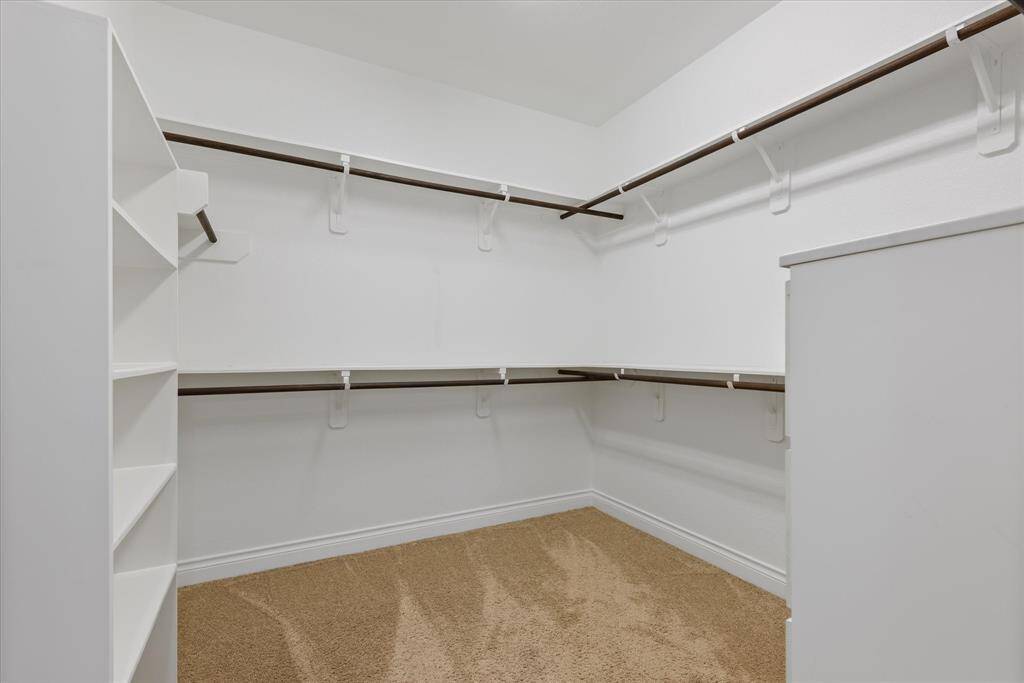 Expansive walk-in closet with ample shelving and hanging space, offering plenty of room to organize your wardrobe.