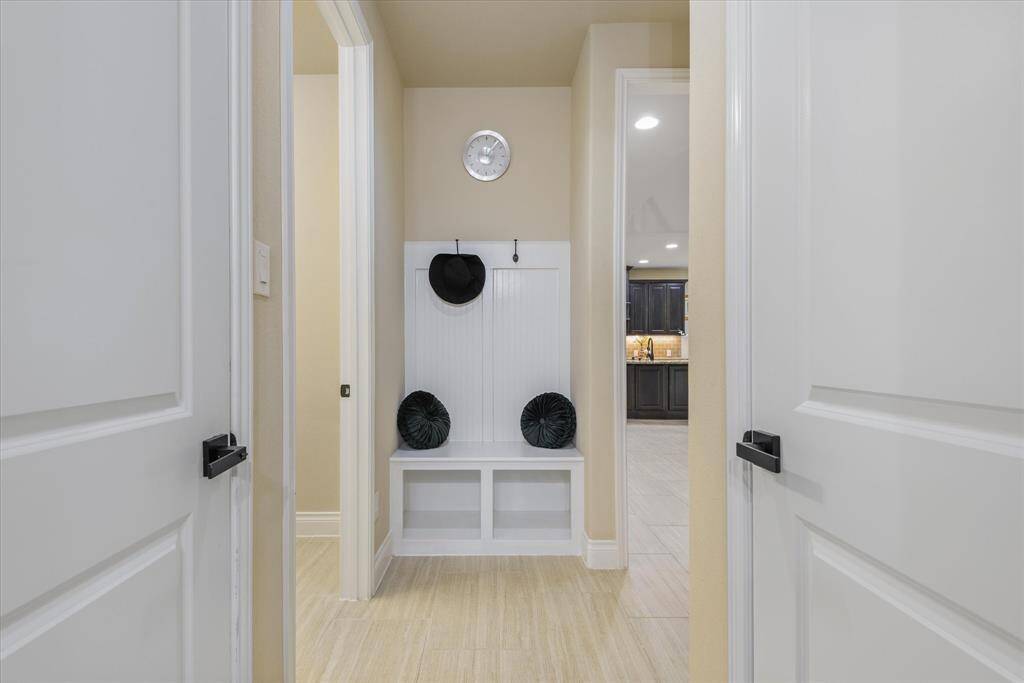 Functional mudroom area just off the garage, featuring a built-in space to keep things organized and tidy.