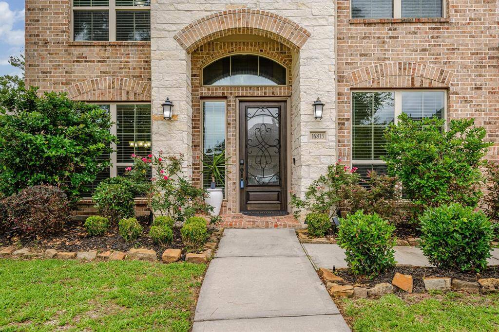 Step up to a warm welcome—this inviting front door sets the tone for the comfort and style found inside.