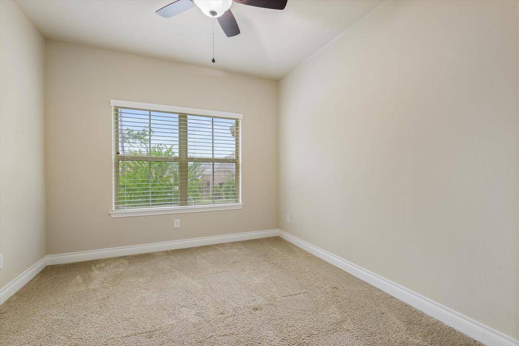 Bedroom 2 - Bright bedroom with ample closet space, large windows, and neutral tones that create a calm, inviting atmosphere.