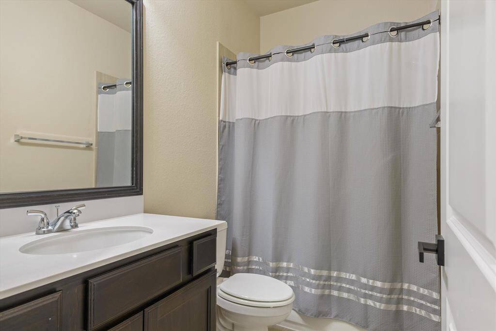 Well-lit upstairs bathroom featuring modern fixtures, a spacious vanity, and a clean, fresh design.