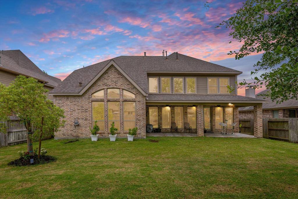 Backyard at twilight, glowing with soft lighting that highlights the peaceful outdoor space and inviting atmosphere.