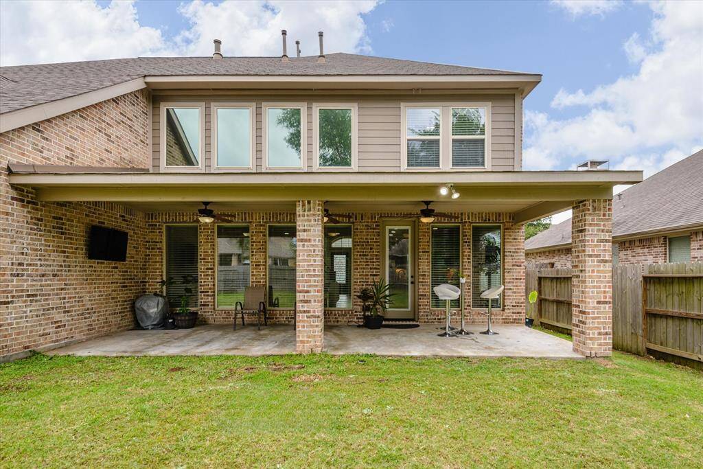 Covered patio featuring a hanging TV, creating the perfect spot for outdoor entertainment and relaxation.
