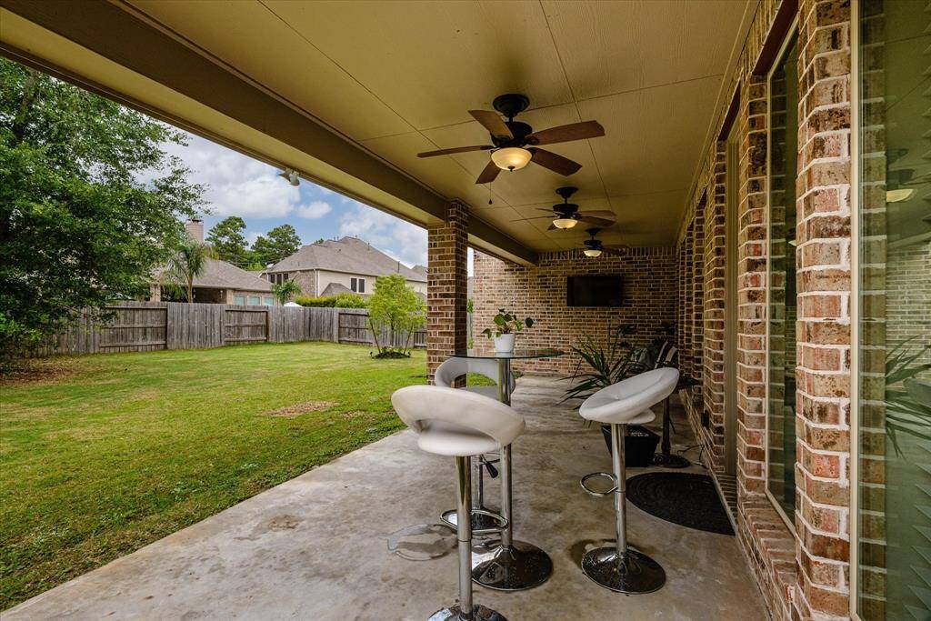 Outdoor patio equipped with ceiling fans, providing a cool and comfortable space to enjoy fresh air year-round.