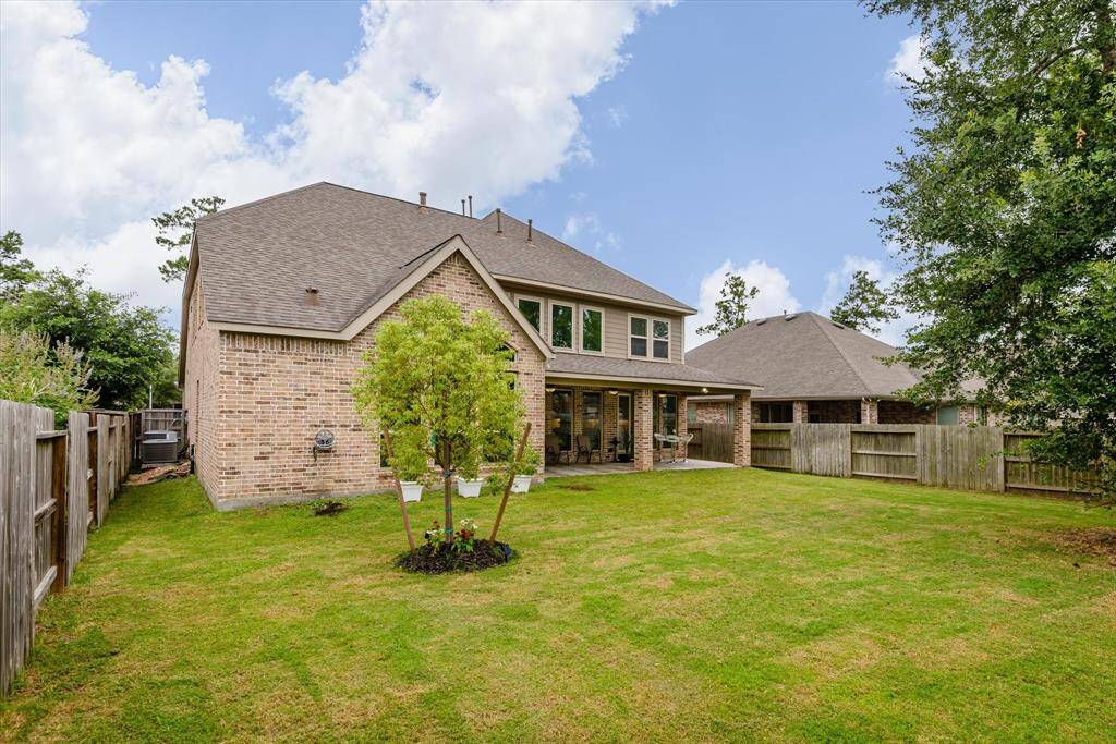 Backyard captured from a different angle, showcasing the expansive green space.