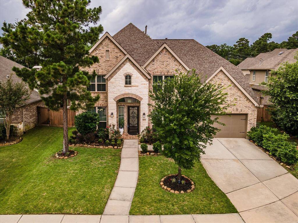 Aerial drone shot highlighting the full exterior of the home, showcasing its design from above.