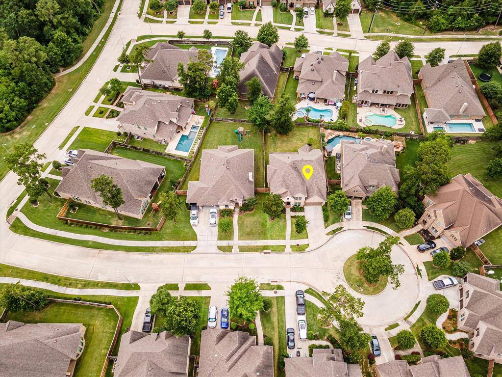 Aerial drone view capturing the entire street, showcasing the neighborhood’s charm and the home’s location.