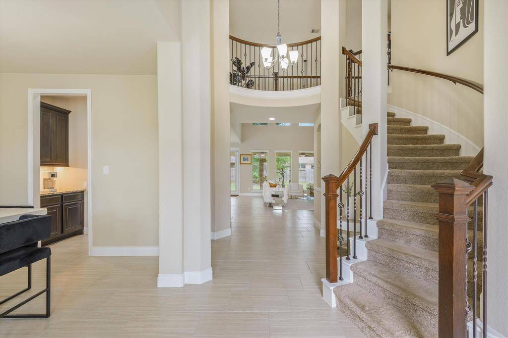 Step inside to a bright entryway with soaring ceilings and a beautiful staircase—an impressive welcome you'll want to see in person!