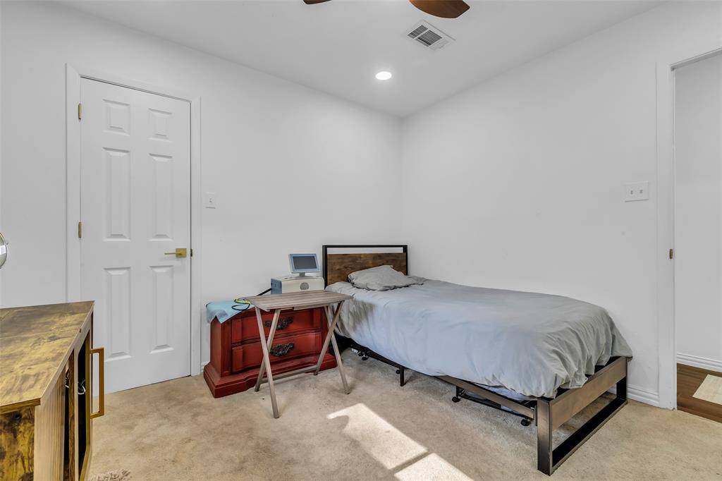 Second bedroom with ample space, updated ceiling fan, and closet. Clean, minimalist aesthetic ready for personalization.