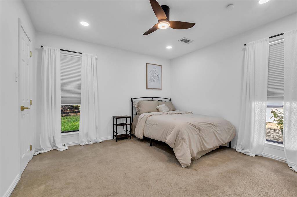 Third Bedroom, highlighting dual windows with backyard views and soft light. Roomy and relaxing.