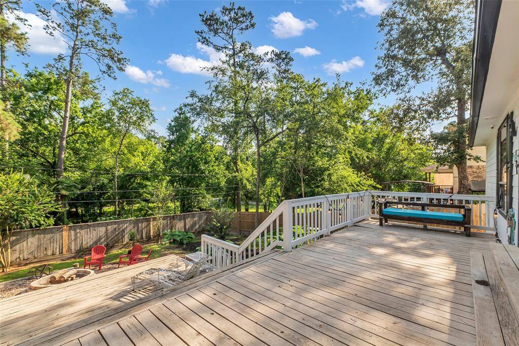 Expansive upper deck with plenty of space for lounging or outdoor dining, overlooking a beautifully wooded lot with no back neighbors.