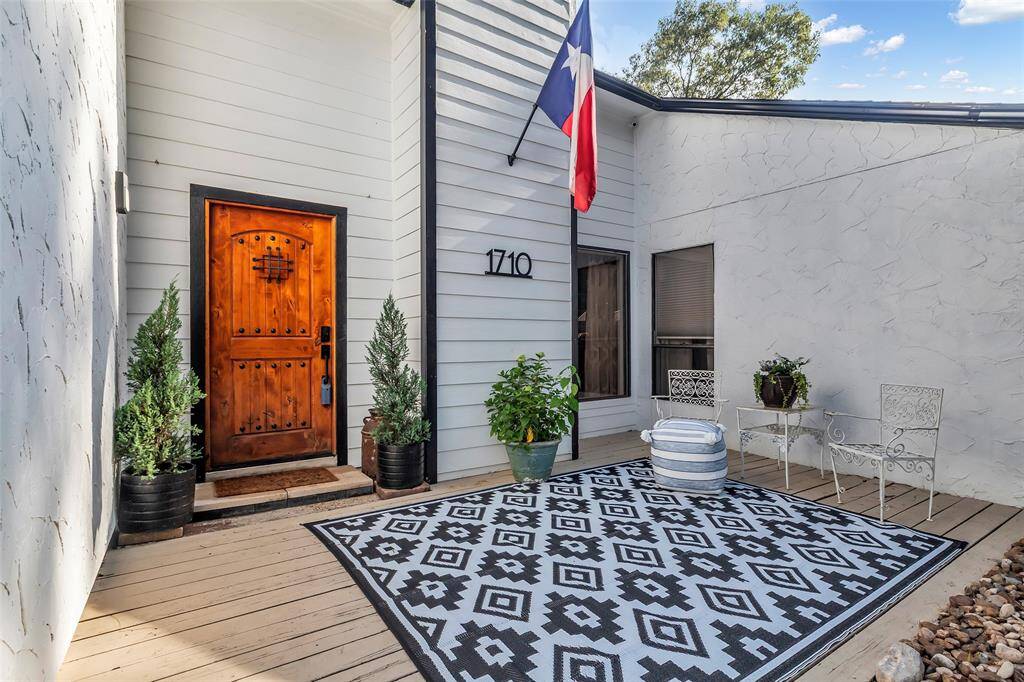 Up-close look at the front entry – stylish and welcoming with symmetry in landscaping and a modern rustic charm.