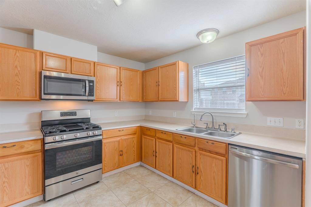 The Kitchen offers plenty of storage, stainless steel appliances, and a seamless connection to the main living area
