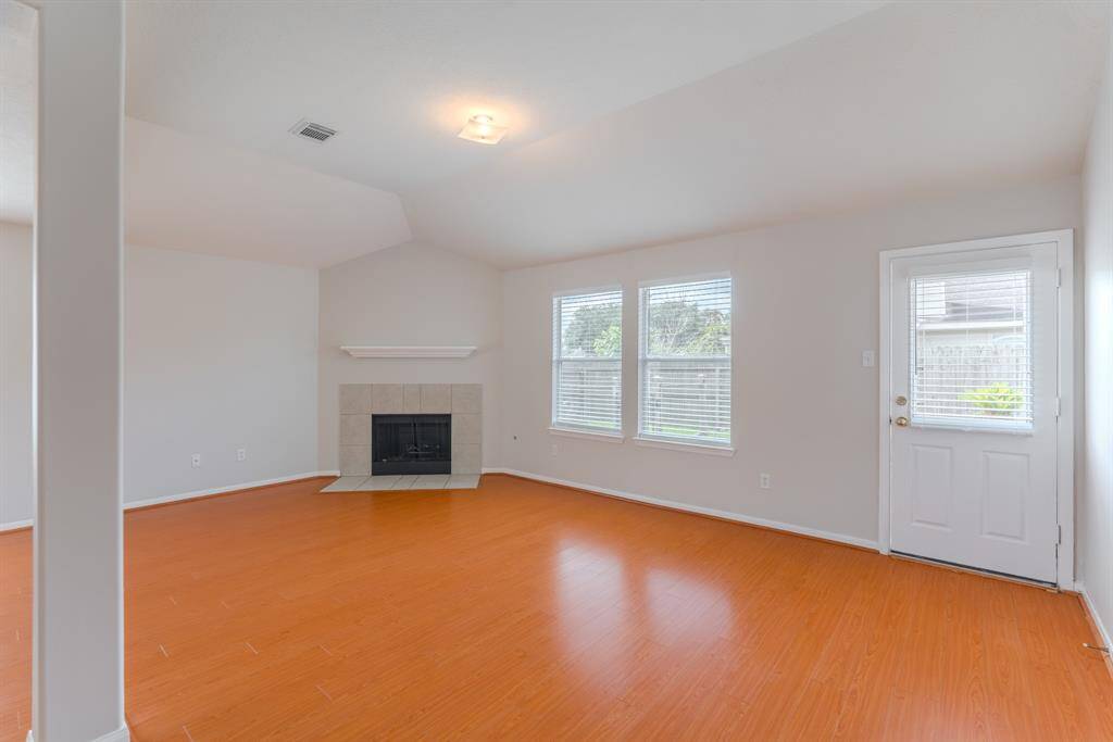 The spacious living area is filled with natural light and features a cozy fireplace for those colder winter days.