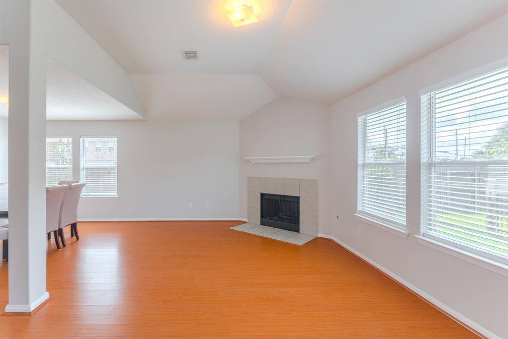 The spacious living area is filled with natural light and features a cozy fireplace for those colder winter days.