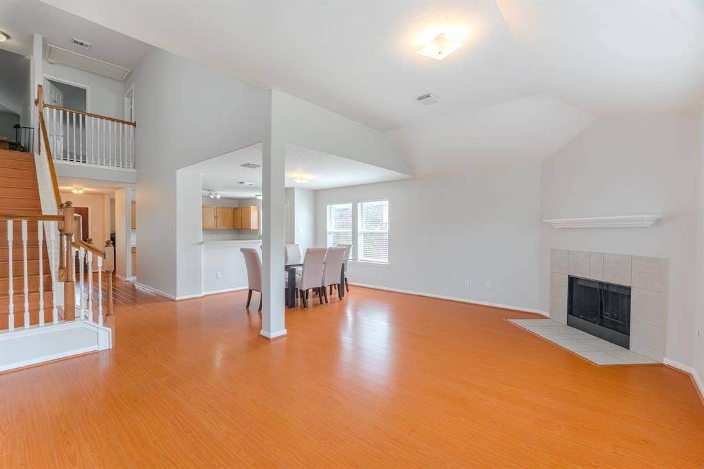 The spacious living area is filled with natural light and features a cozy fireplace for those colder winter days.