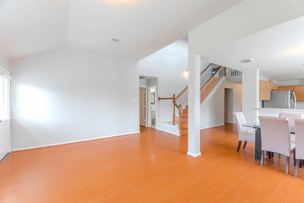 The spacious living area is filled with natural light and features a cozy fireplace for those colder winter days.