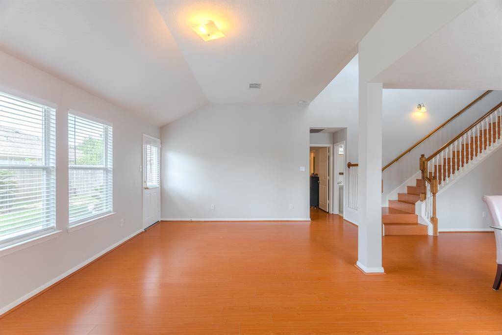 The spacious living area is filled with natural light and features a cozy fireplace for those colder winter days.
