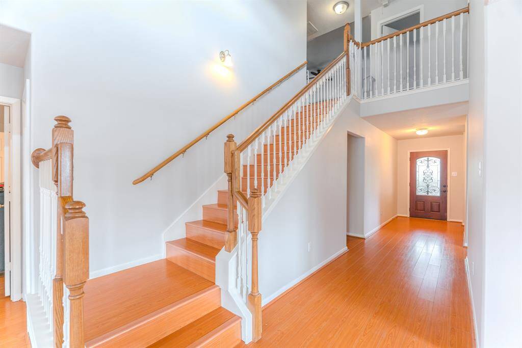 The staircase leads you to the second floor, where you'll find a spacious game room and cozy secondary bedrooms.